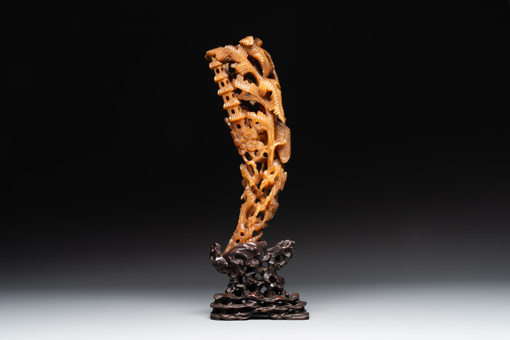 A Chinese buffalo horn carving of a landscape with a pagoda on wooden stand, Qing