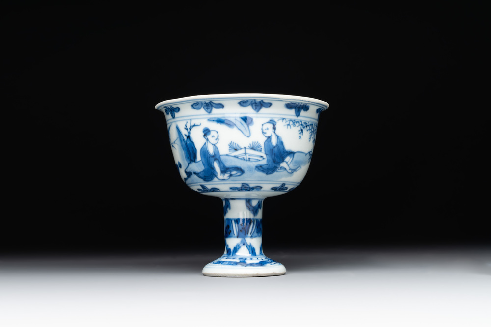 A Chinese blue and white stem cup with scholars in a landscape, Transitional period