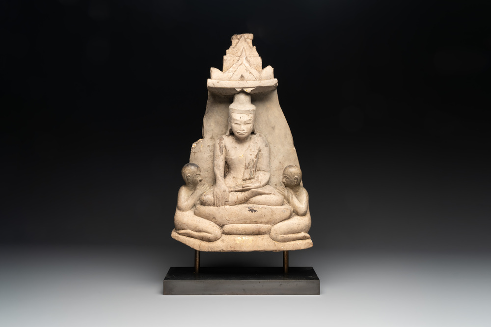 A Burmese limestone stele with Buddha and two attendants with traces of gilding, 19th C.