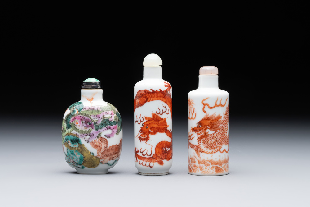 Three Chinese famille rose and iron-red 'Buddhist lion' and 'dragon' snuff bottles, 19th C.