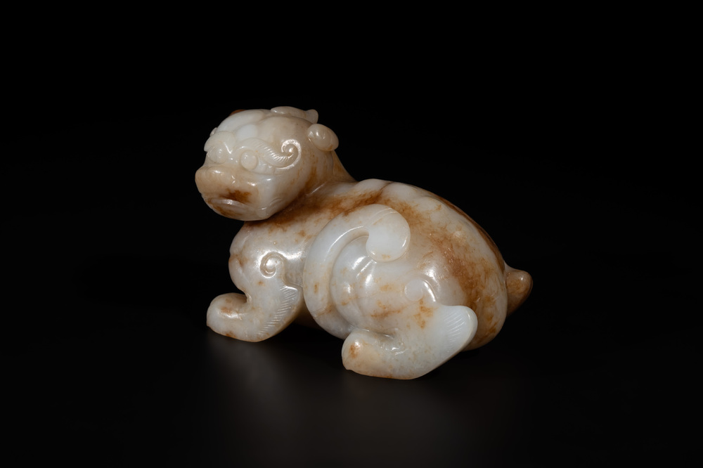 A large Chinese white and russet jade sculpture of a mythical beast, 17/18th C.