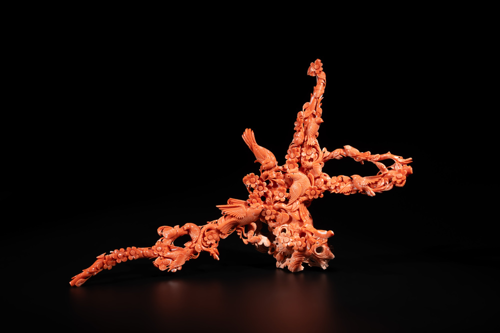 A Chinese red coral group of birds among flowering branches, 19/20th C.
