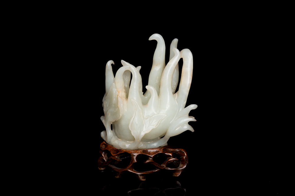 A fine Chinese white jade Buddha's hand on wooden stand, Qing