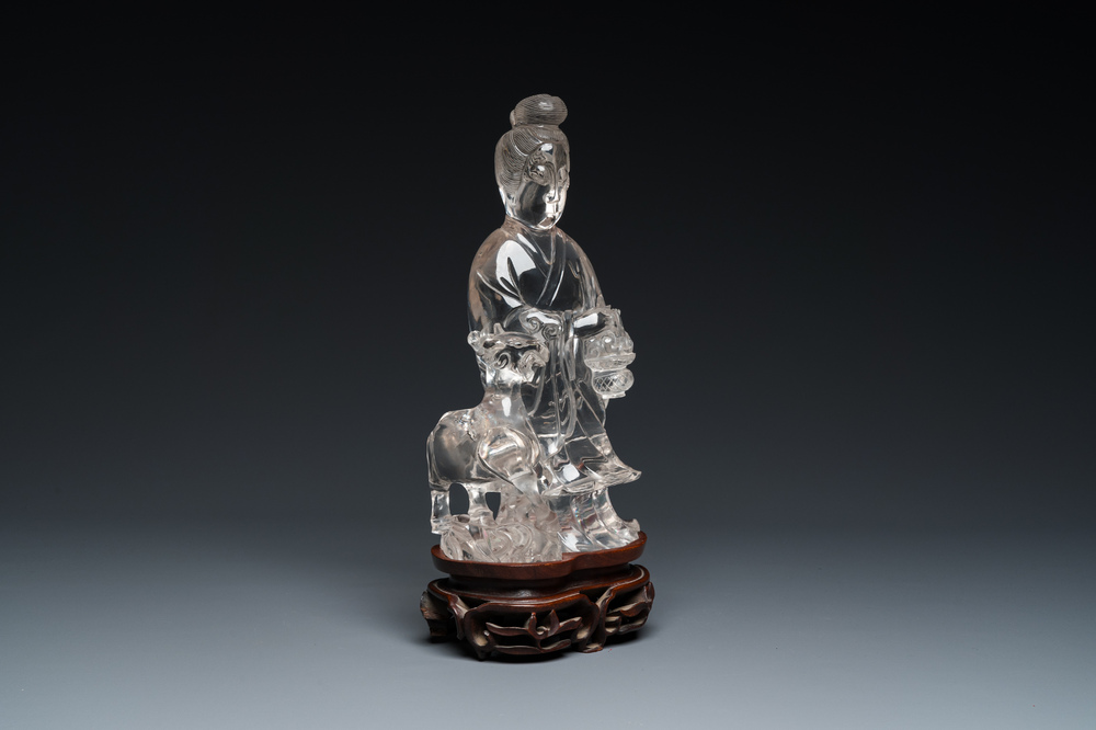 A Chinese rock crystal sculpture of Lan Caihe on wooden stand, 19th C.