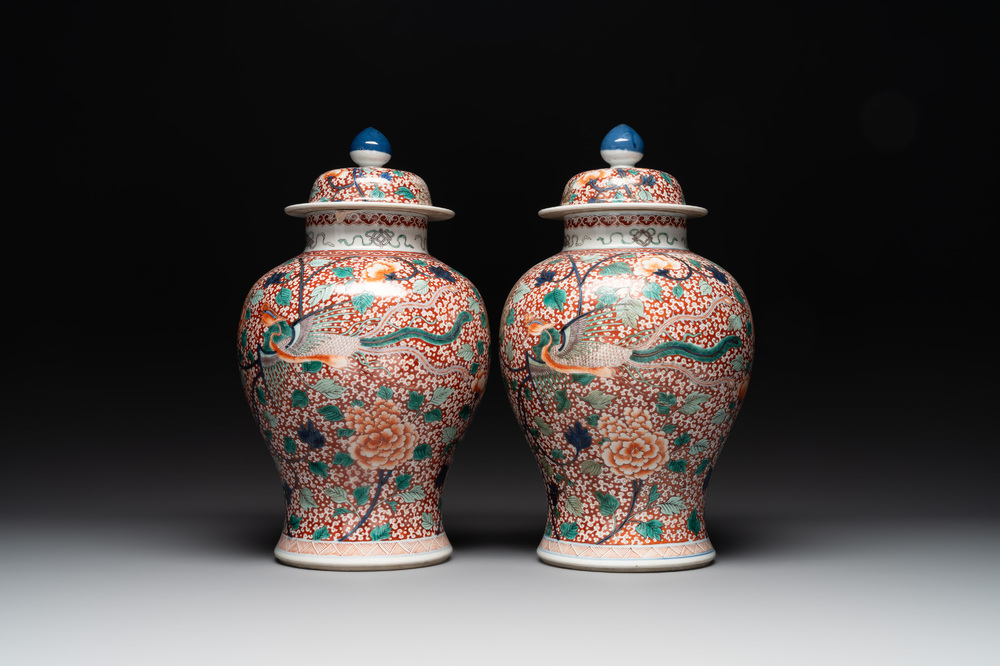 A pair of Chinese famille verte 'phoenix' vases and covers, 19th C.