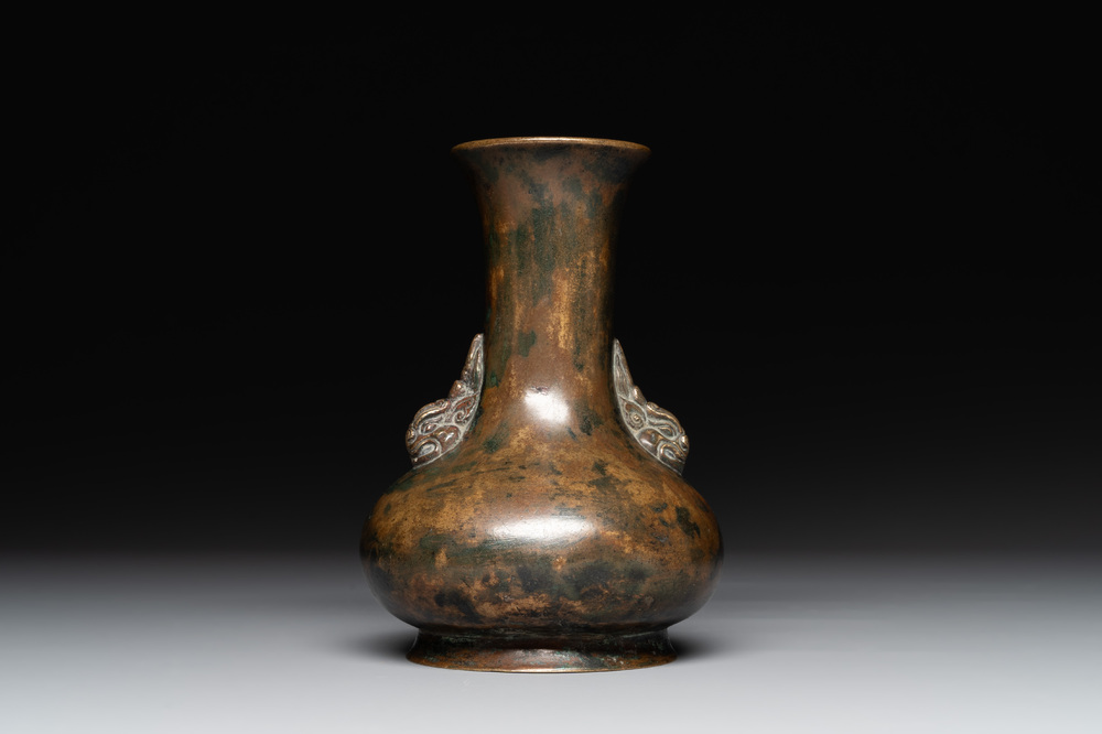 A small Chinese bronze bottle vase with lion-form handles, Qing, 17th C.