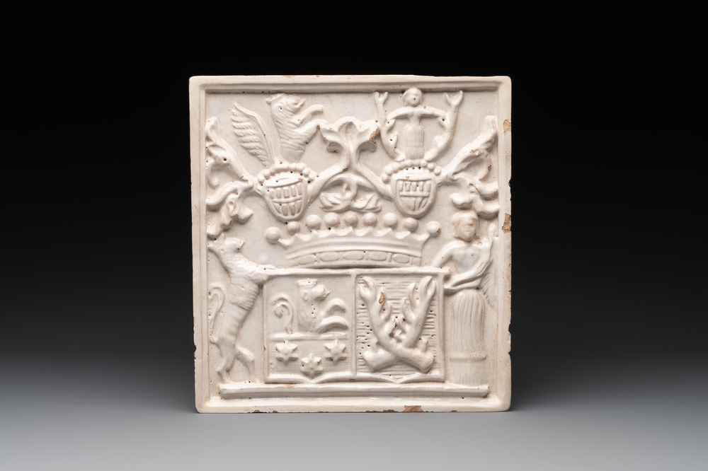 A rare white-glazed stove tile with an alliance coat of arms, Germany or Switzerland, 17th C.
