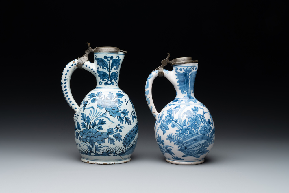 Two Dutch Delft blue and white jugs with pewter lids, 17/18th C.