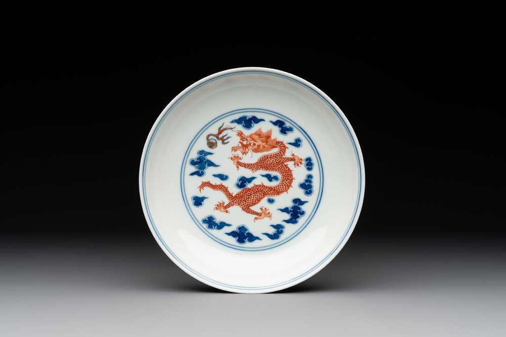 An imperial Chinese blue, white and iron-red 'dragon' plate, Qianlong mark and of the period