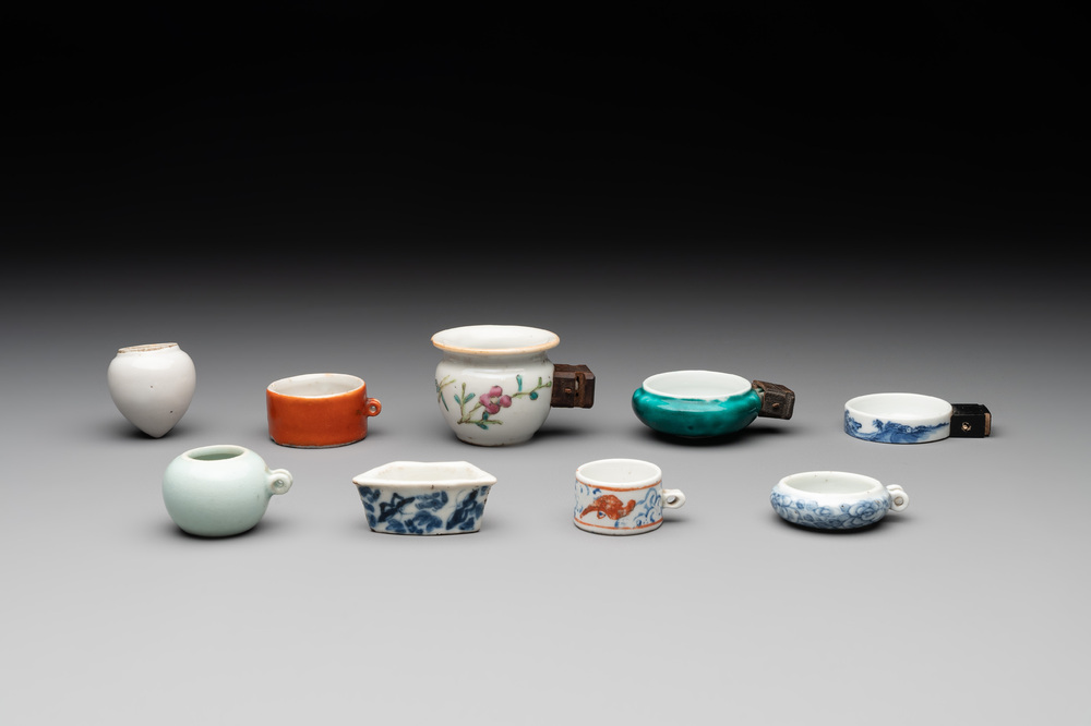 A collection of nine Chinese blue and white, monochrome and famille rose bird feeders, 19th C.