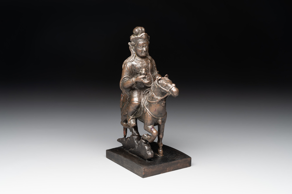 A rare Chinese bronze Vaishravana on horseback with wooden stand, Yuan