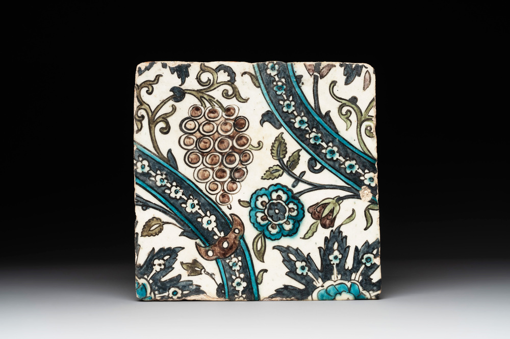 A Syrian Damascus Iznik-style tile with grape and flower scrolls, early 17th C.