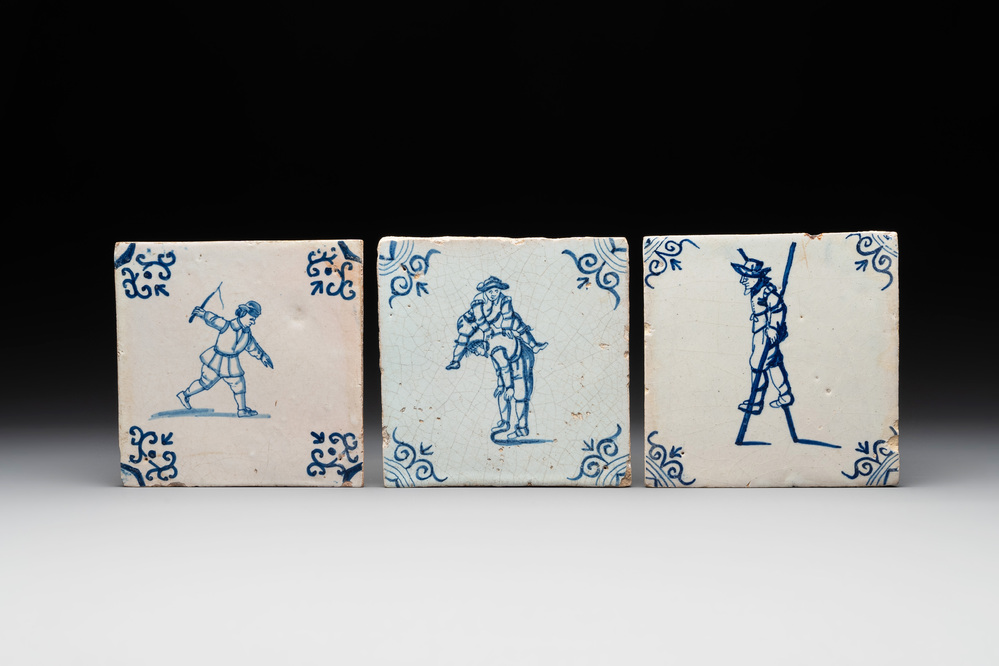 Three blue and white Dutch Delft tiles with children's games, 17th C.