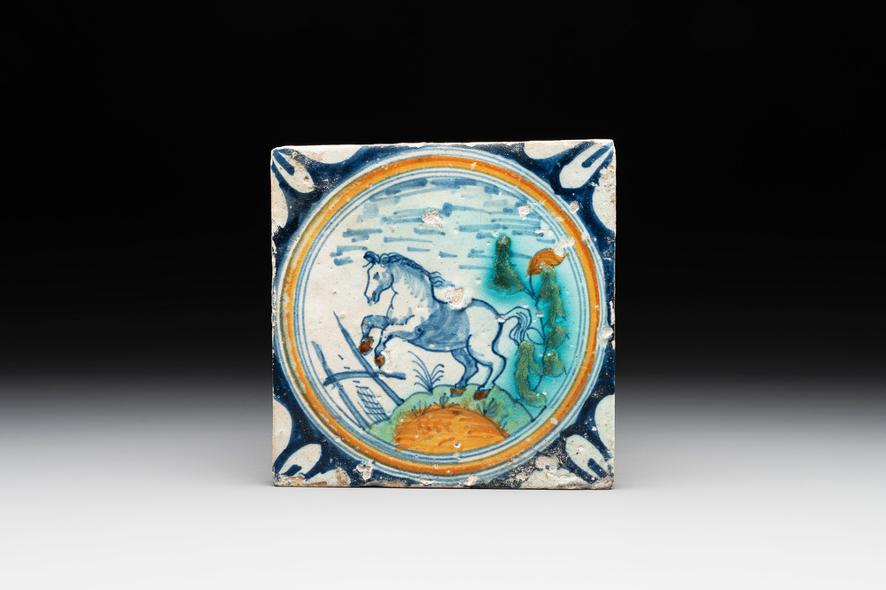 A polychrome Dutch Delft maiolica 'medallion' 'horse' tile, late 16th C.