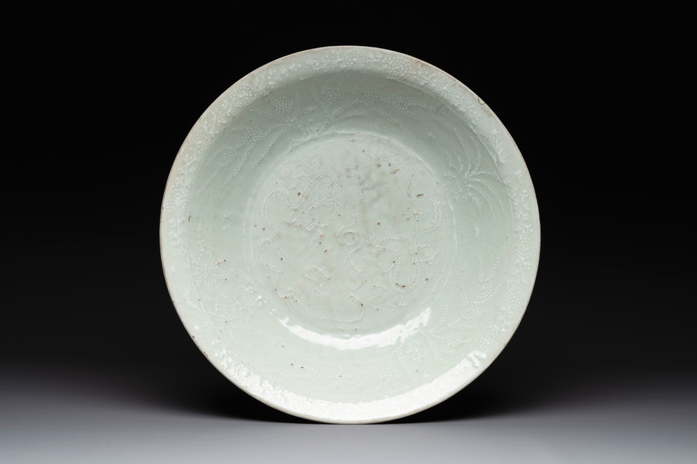 A rare Chinese Swatow slip-decorated pale-green-glazed 'dragon' dish, Ming