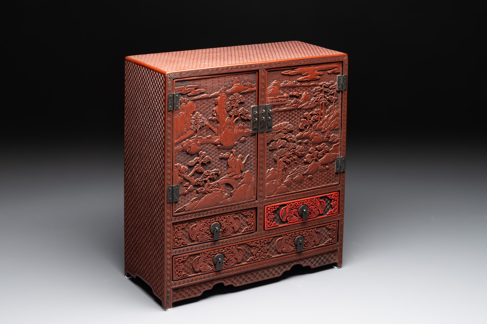 A Chinese cinnabar lacquer 'mountainous landscape' cabinet, 19th C.