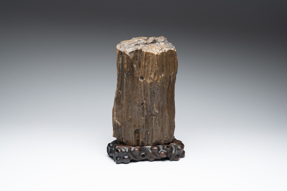 A Chinese petrified wood scholar's rock on wooden stand, 17/18th C.