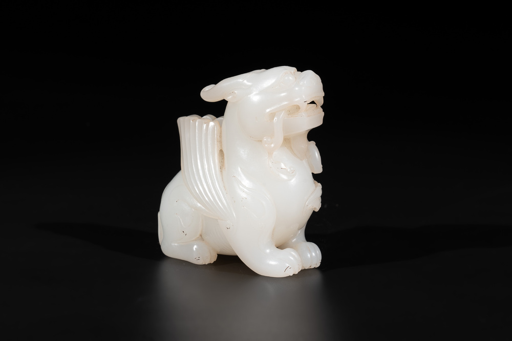 A Chinese white jade carving of a mythic animal, 19/20th C.