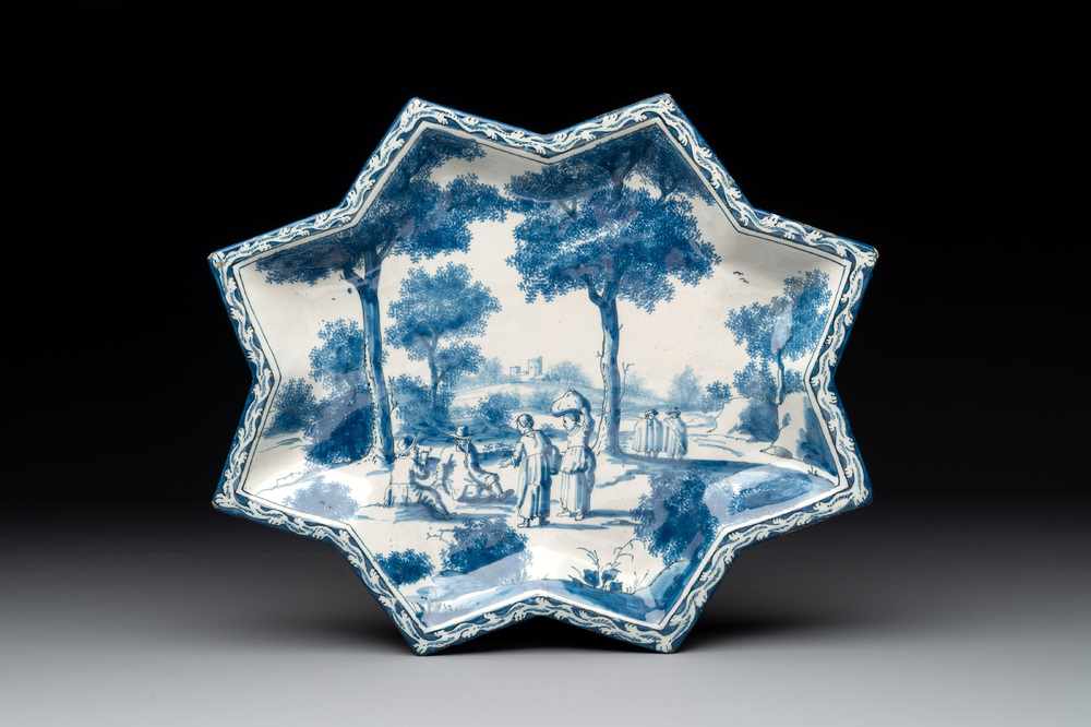 A rare blue and white Dutch Delft star-shaped dish with travellers in a landscape, early 18th C.