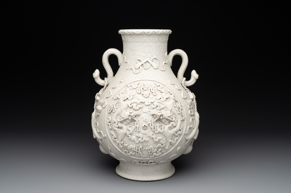 A Chinese white-glazed biscuit 'hu' vase with dragons, Qianlong mark, 19/20th C.