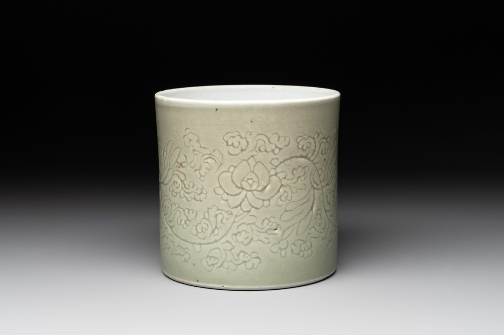A Chinese incised celadon-glazed 'lotus scroll' brush pot, Kangxi