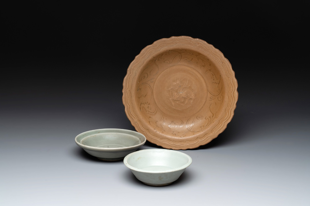 A Chinese Longquan celadon plate and two saucer dishes, Ming