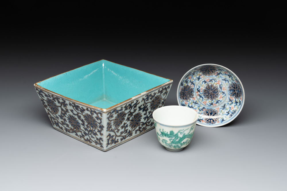 A Chinese gilt-decorated blue and white 'lotus scroll' square bowl, a saucer and a doucai 'dragon' cup, Daoguang mark and of the period