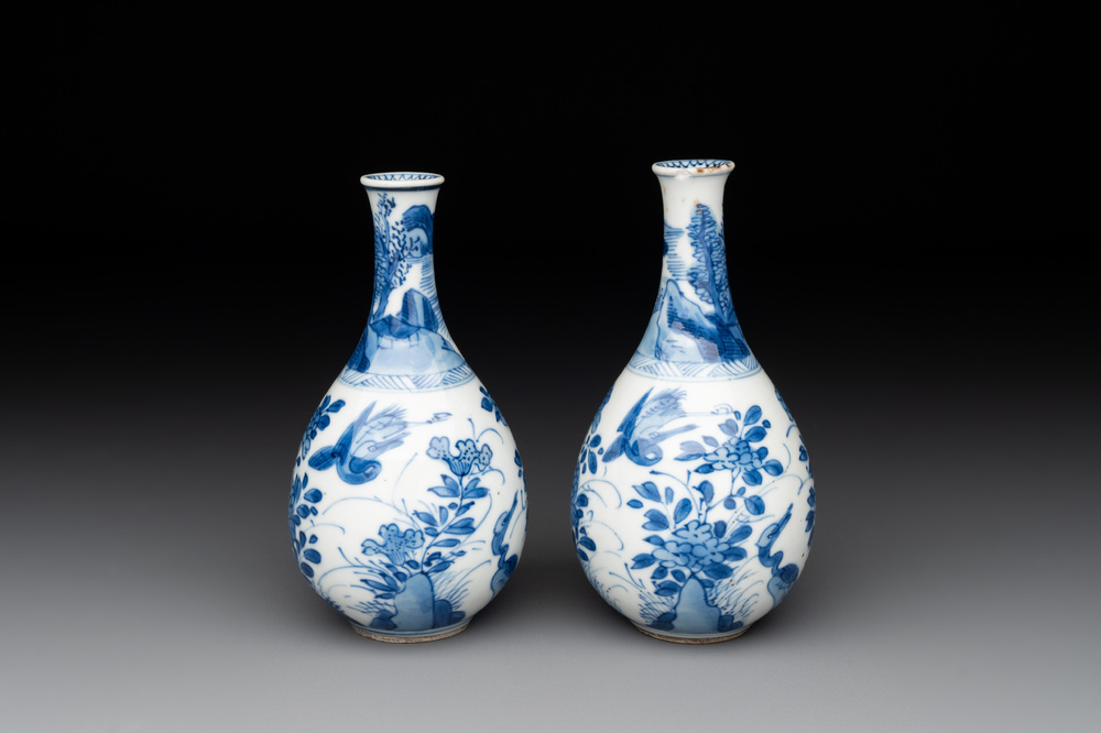A pair of Chinese blue and white pear-shaped vases with cranes among flowering branches, Kangxi