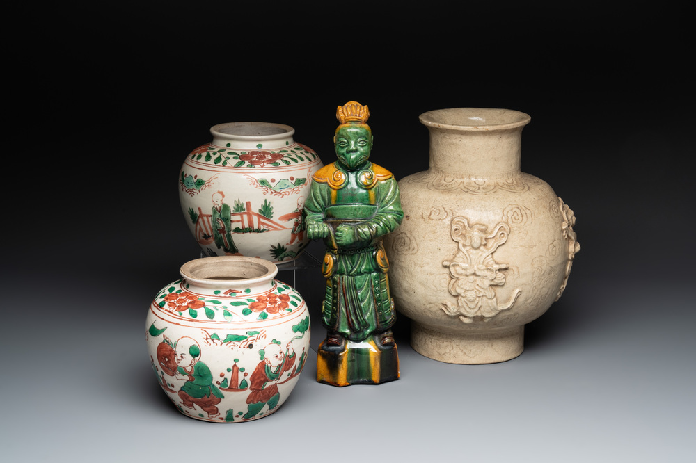 A Chinese sancai figure of Garuda, a cream-glazed vase and a pair of wucai jars, 19th C.