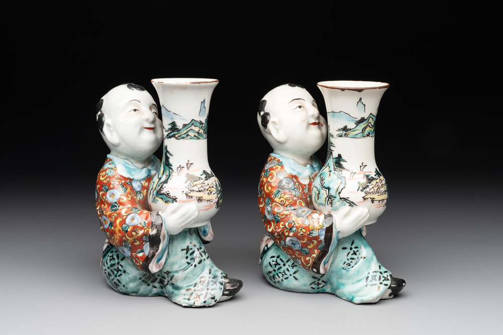 A pair of Japanese polychrome boy-shaped vases, 19th C.
