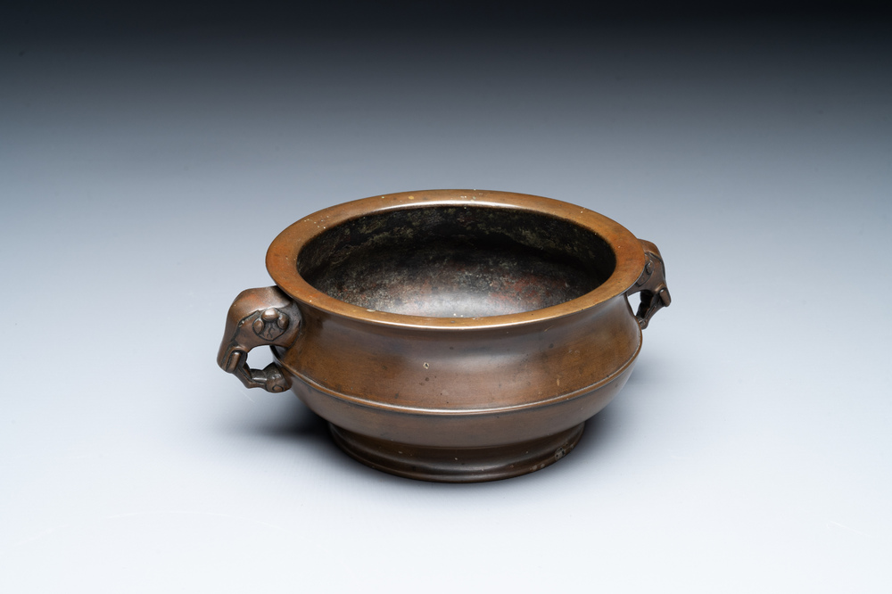 A Chinese bronze elephant-head-handled censer, Wan Shou Wu Jiang 萬壽無疆 mark, 19th C.