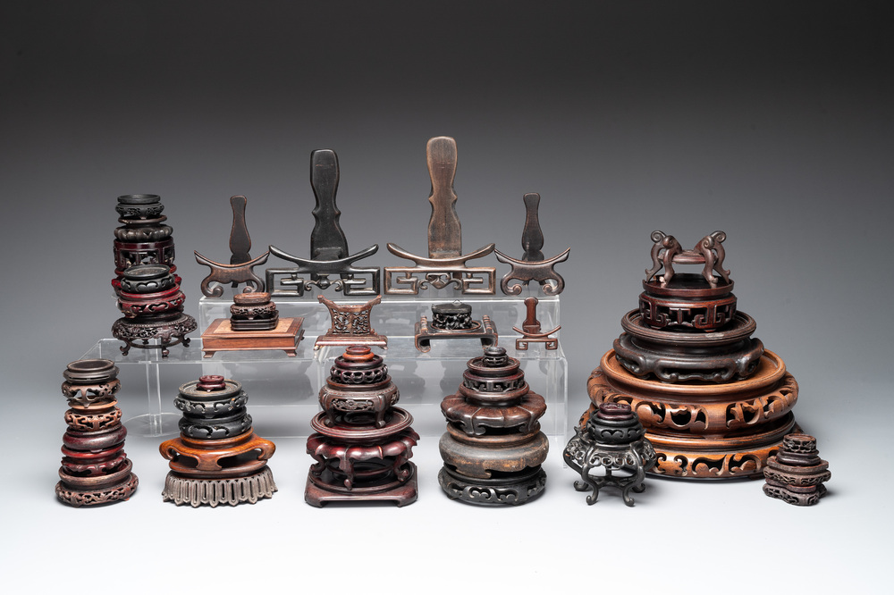 A collection of 55 Chinese wooden stands, 19/20th C.