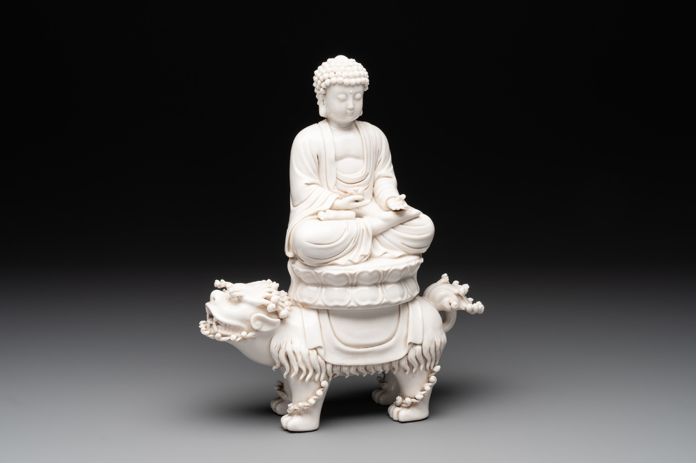 A Chinese Dehua blanc de Chine Buddha seated on a lion, 20th C.