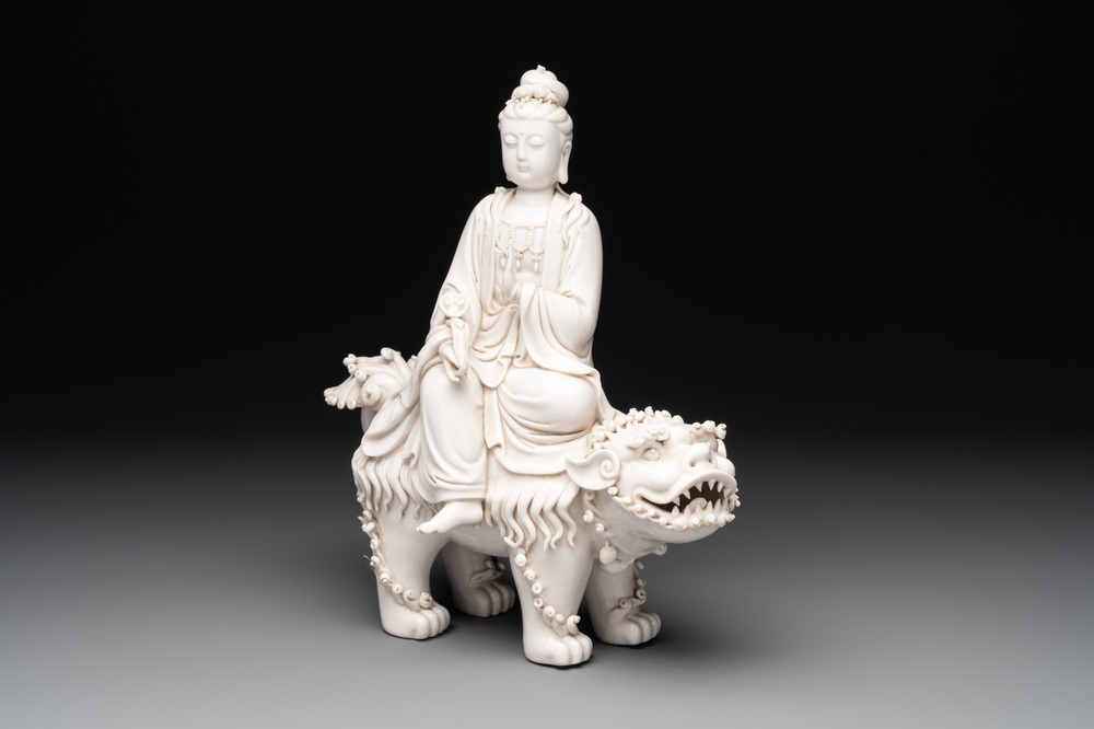 A Chinese Dehua blanc de Chine Guanyin with a ruyi sceptre seated on a Buddhist lion, 20th C.