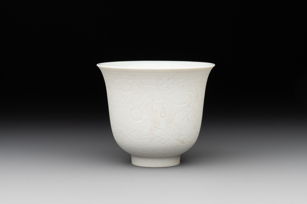 A Chinese white-glazed biscuit 'dragon' cup, Kangxi mark, 19th C.