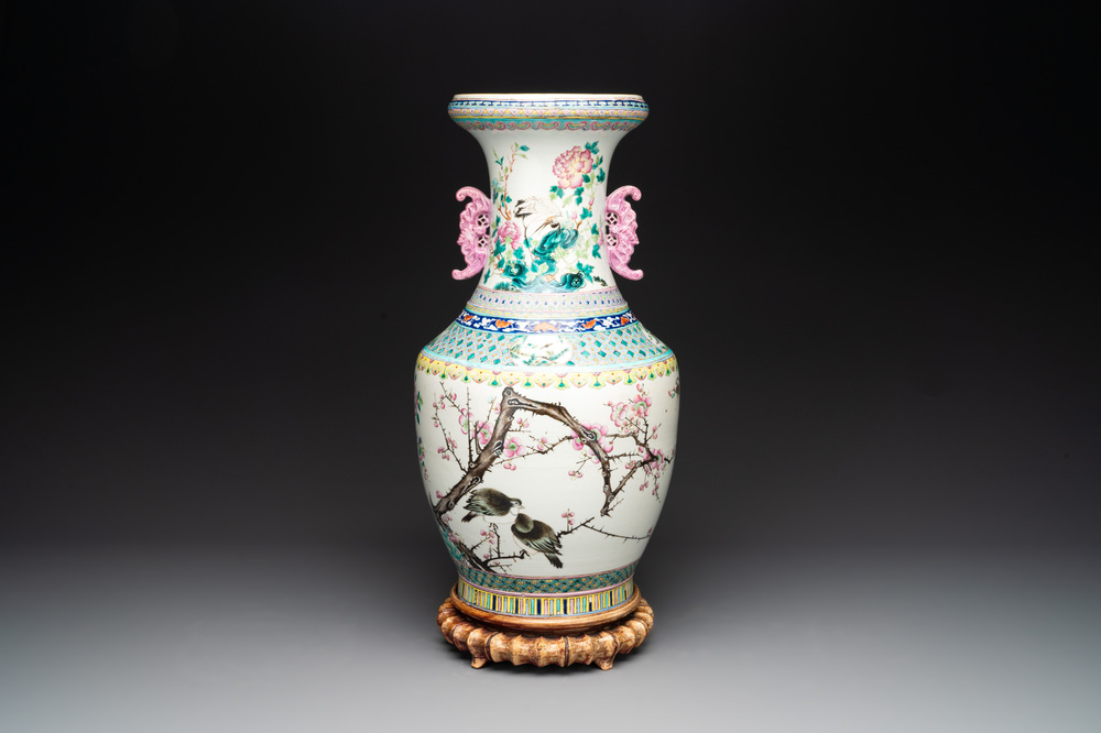 A Chinese famille rose 'magpies and plum blossoms' vase on wooden stand, 19th C.