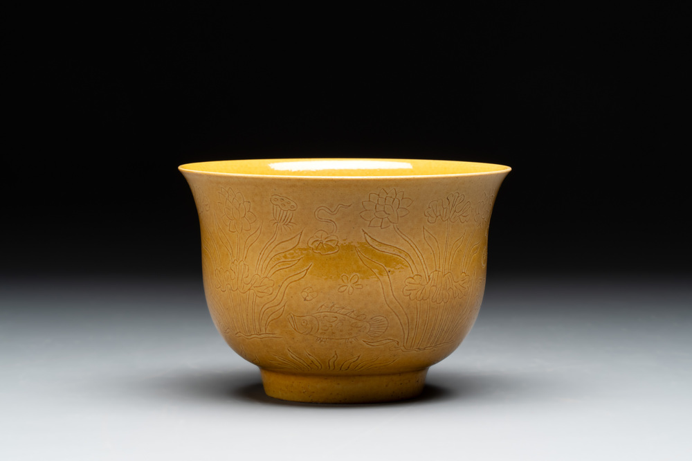 A Chinese yellow-glazed 'anhua' 'carp and lotus' bowl, Kangxi mark, 19th C.