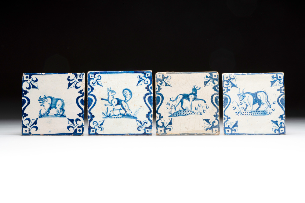 Four blue and white Dutch Delft 'candelabra' tiles with animals, 17th C.