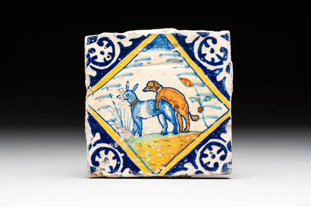 A polychrome Dutch Delft maiolica 'mating dogs' diamond tile, late 16th C.