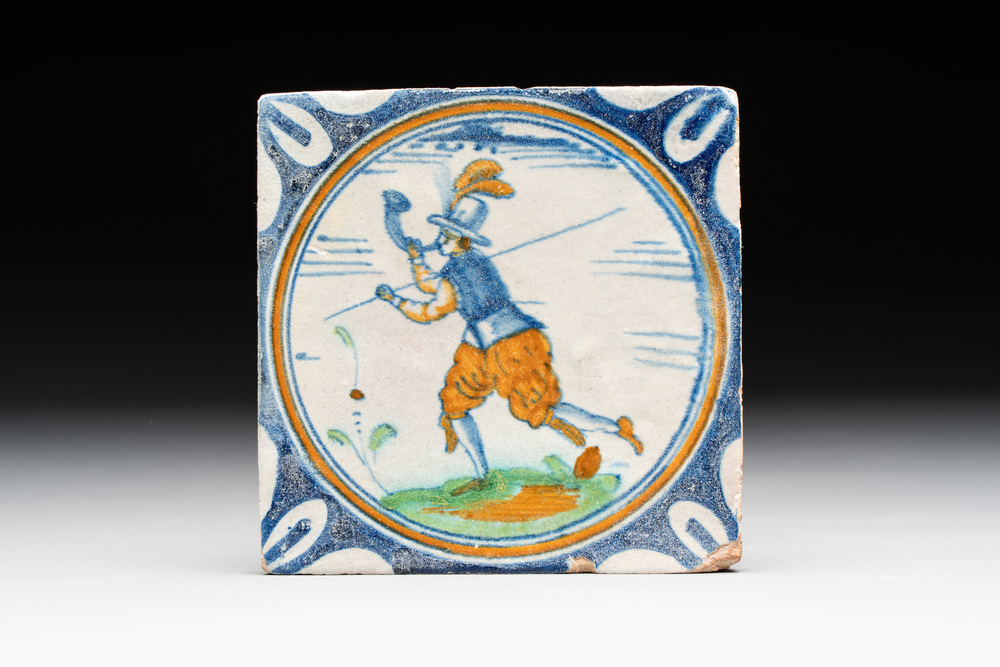 A polychrome Dutch Delft maiolica 'horn blower' medallion tile, late 16th C.