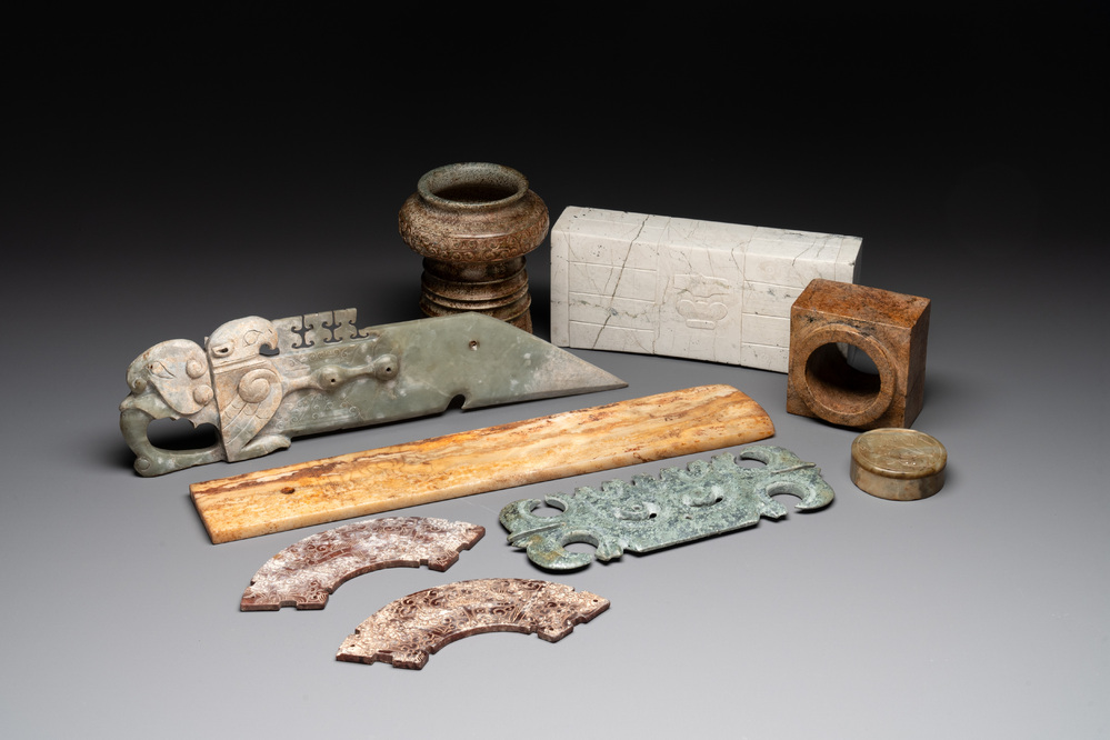 A varied collection of nine Chinese archaistic jade and stone carvings, 20th C.