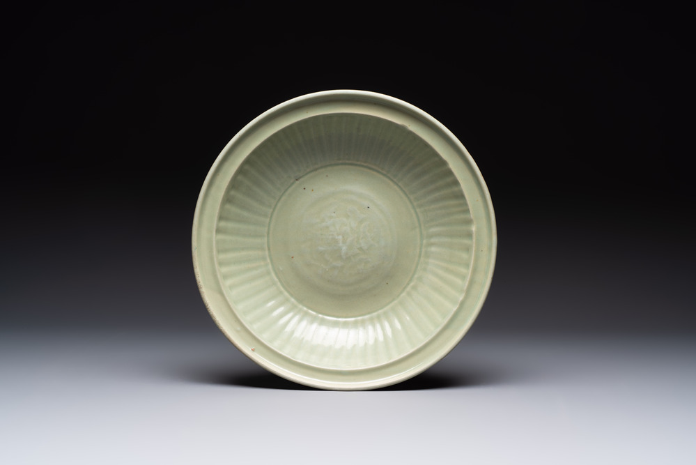 A Chinese Longquan celadon plate with floral design, Yuan/Ming
