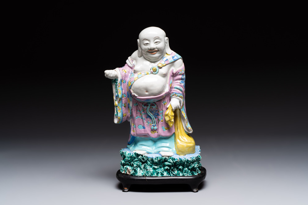 A Chinese famille rose Milefo Buddha on wooden stand, 19th C.