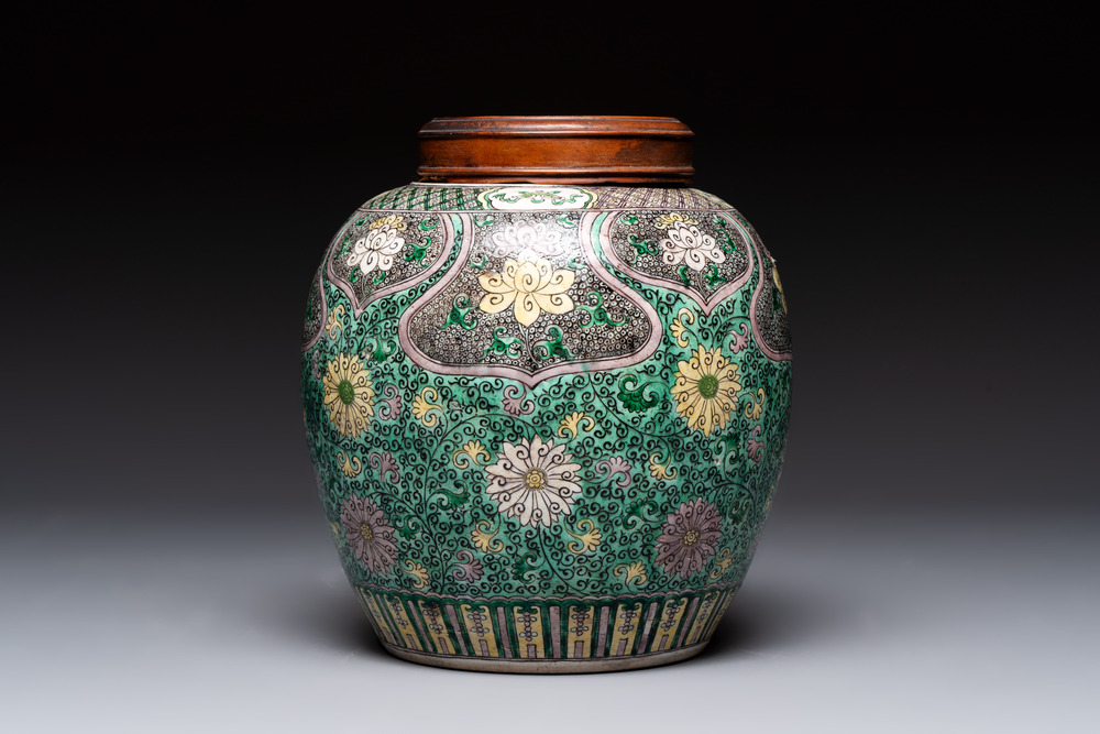 A Chinese verte biscuit 'lotus scroll' jar with wooden cover, Qing