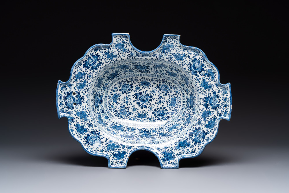 A very rare and large blue and white Dutch Delft double barber's bowl with floral design, late 17th C.