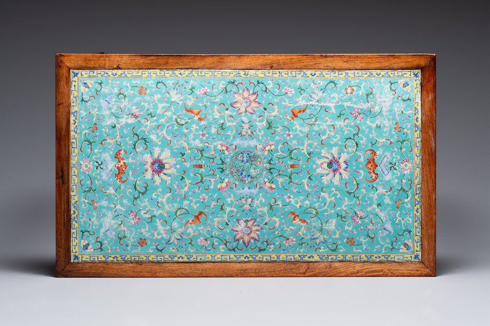 A Chinese famille rose turquoise-ground 'flower scrolls and bats' plaque, later mounted as table, Qianlong