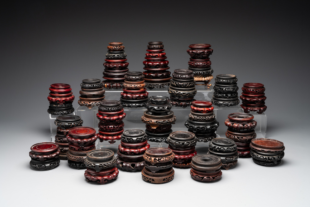 A large collection of 87 Chinese wooden stands, 19/20th C.