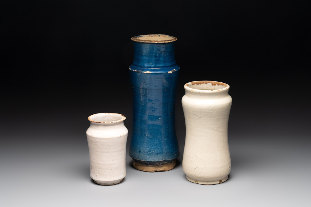 A blue-glazed albarello and two white-glazed albarelli, Spain, 17th C.