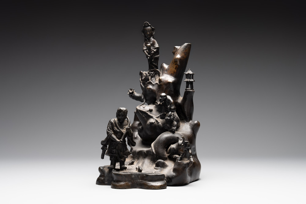 A rare Chinese bronze group depicting two immortals and various animals in a mountainous landscape, Ming