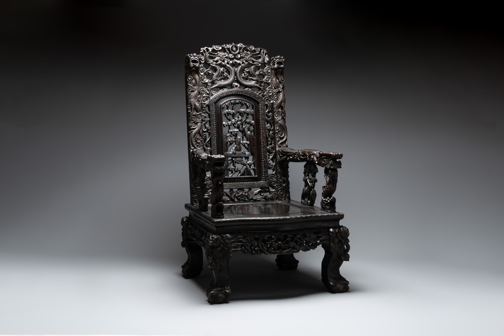 A richly carved Chinese lacquered hongmu armchair, Canton, 19th C.